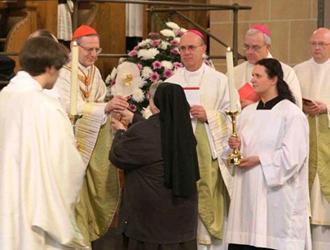 Cardinal Amato receiving reliquary from Sister Magdalena Krol